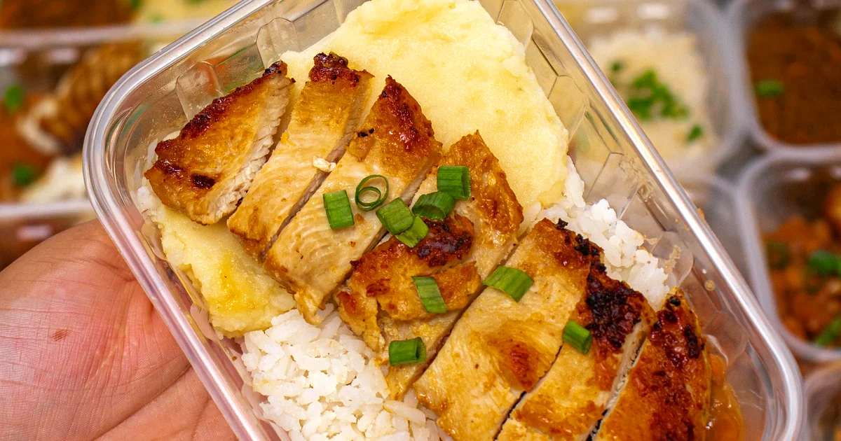 Grilled chicken with rice and beans in a meal prep bowl