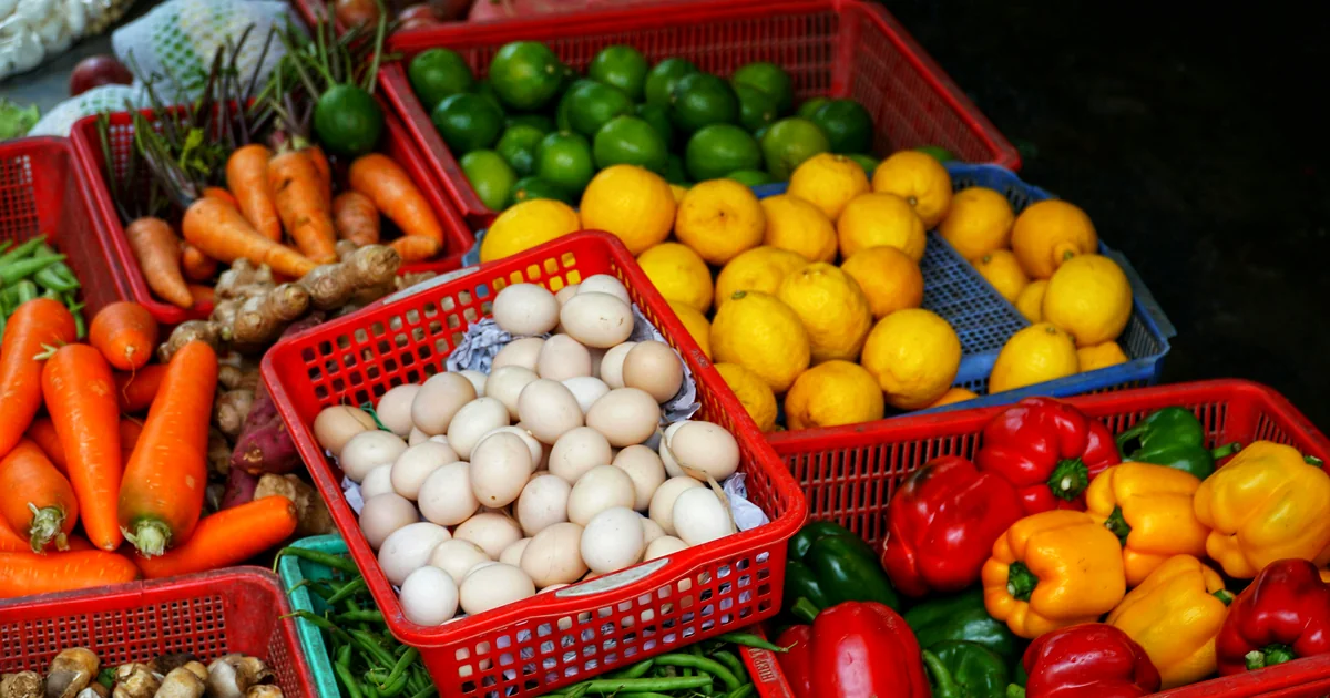 Fresh eggs and vegetables at a grocery market